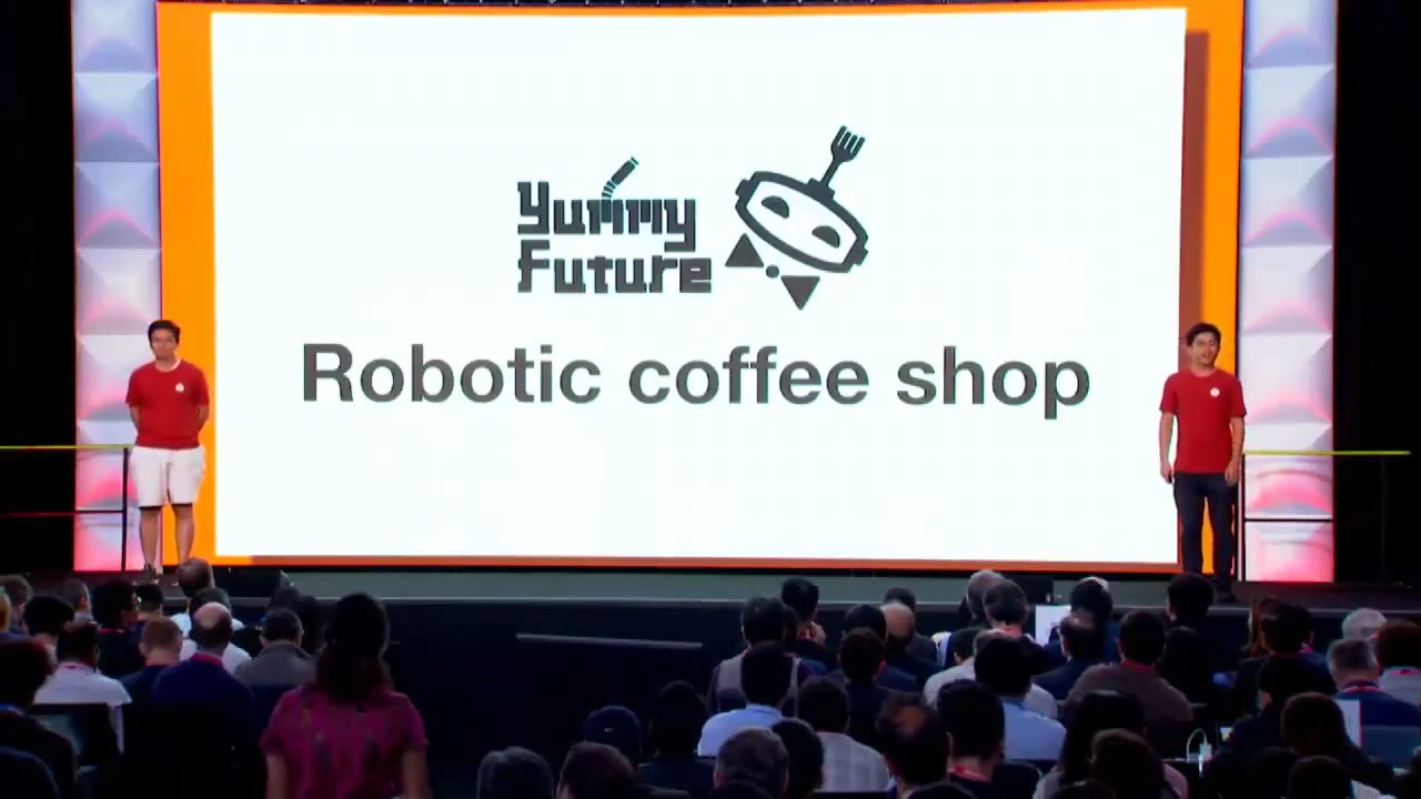Both founders on the Y Combinator S19 Demo Day stage, screen reading Robotic coffee shop